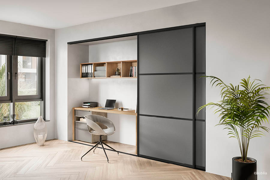 Homeoffice mit großflächiger dunkler Schiebetür zur flexiblen Abtrennung des Arbeitsplatzes | Schiebetüren als Raumtrenner | Aktuelles – Trends – News im September 2026 | Möbeltischlerei Tischlerei Möbeltischler Möbelmanufaktur Hamburg
